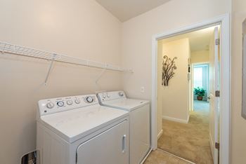 A white washer and dryer in a laundry room.